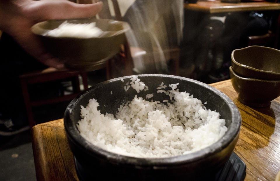 Cho Dang Gol serves white rice at the table in a hot stone pot. At the end of the meal, a waiter will scoop up the remaining burnt rice bits at the end of the meal and add a hot tea, forming a kind of toasted rice porridge.