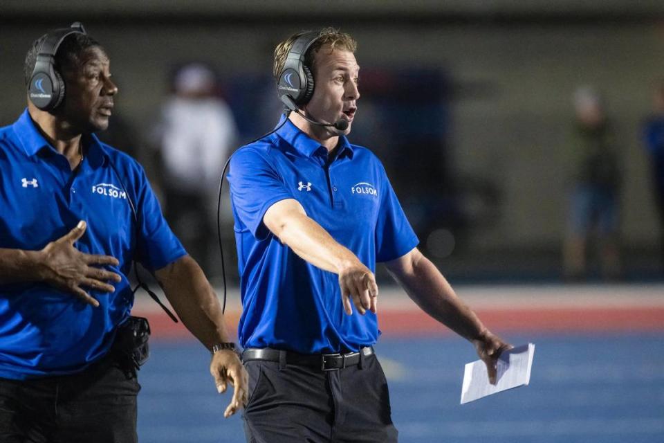 Folsom coach Paul Doherty, right, calls a play from the sidelines in the first half of the game on Friday at Folsom High School.
