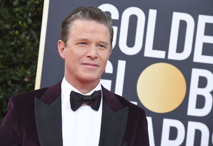 Billy Bush in a tuxedo posing at the 2020 Golden Globes