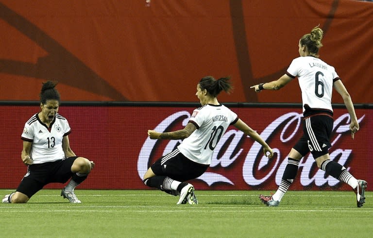 Germany's Celia Sasic (L) celebrates after scoring a goal during their FIFA Women's World Cup quarter-final match against France, at the Olympic Stadium in Montreal, Canada, on June 26, 2015