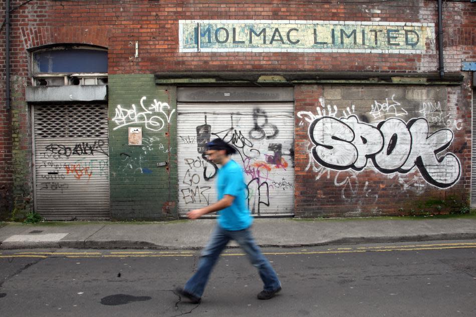 A man walks past graffiti in Dublin.