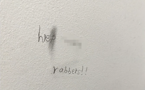 A little girl wrote this message on a bathroom wall: 'Help... robbers!!'