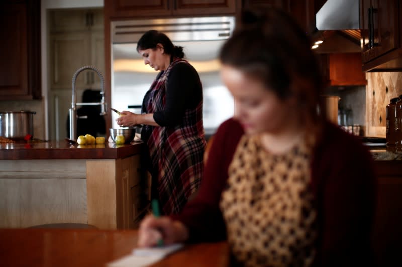 Loreta and Kendra Miller, relatives of Rhonita Miller who was killed along with four of her children by unknown assailants, are seen in their home in La Mora