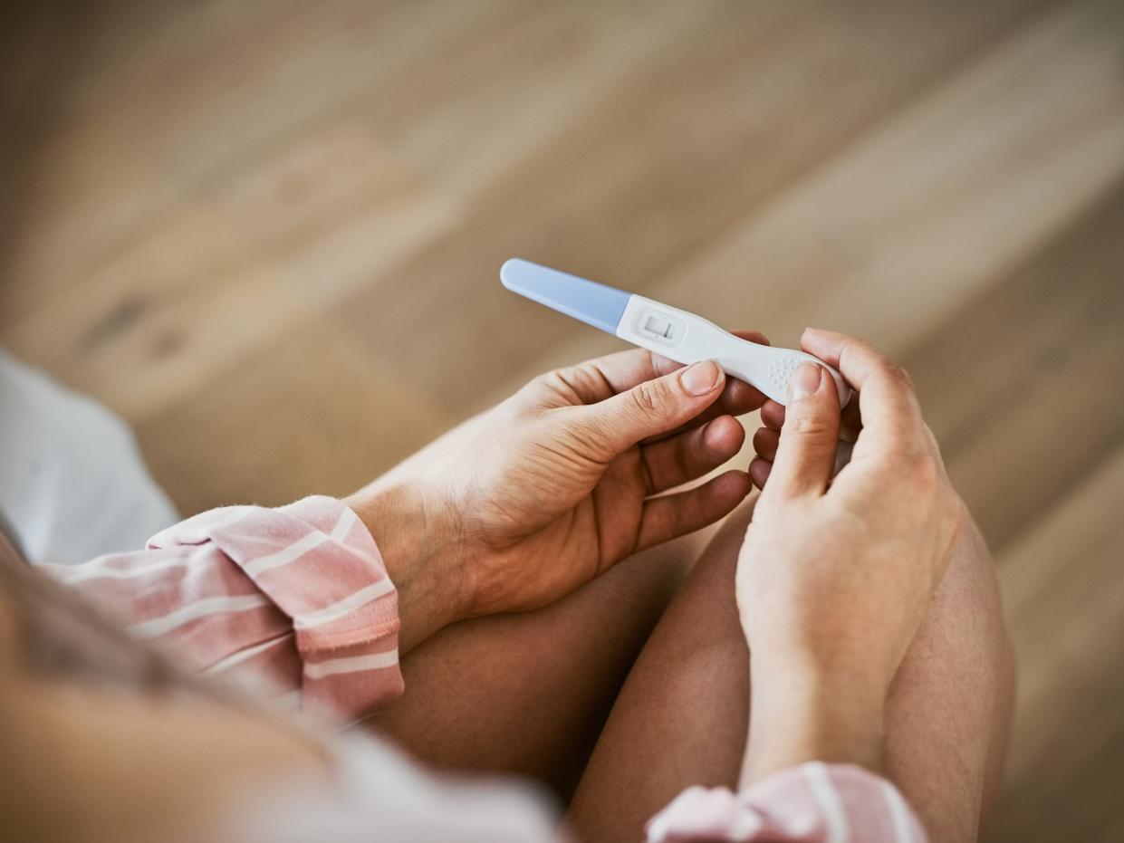 Cropped shot of an unrecognizable woman holding a negative pregnancy test