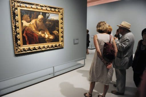 Visitors look at the painting "Sacrifice of Isaac" by Italian artist Michelangelo Merisi known as Caravaggio, in June 2012 at the Fabre Museum in Montpellier, France. Italian art experts have reportedly discovered around 100 drawings and a number of paintings by the young Renaissance master Caravaggio in a find that could be worth up to 700 million euros