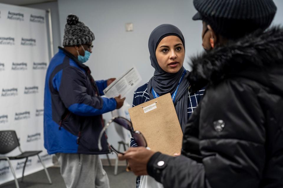 Site coordinator Lamis Alnajjar, center, helps a woman with information regarding an appointment to get her taxes prepared at the Accounting Aid Society Northwest Financial Hub in Detroit on March 16, 2023. Households with income below $60,000 can qualify for free tax preparation unless they include things such as including rental income; business use of the home, or someone who is self-employed with inventory or costs of goods sold.