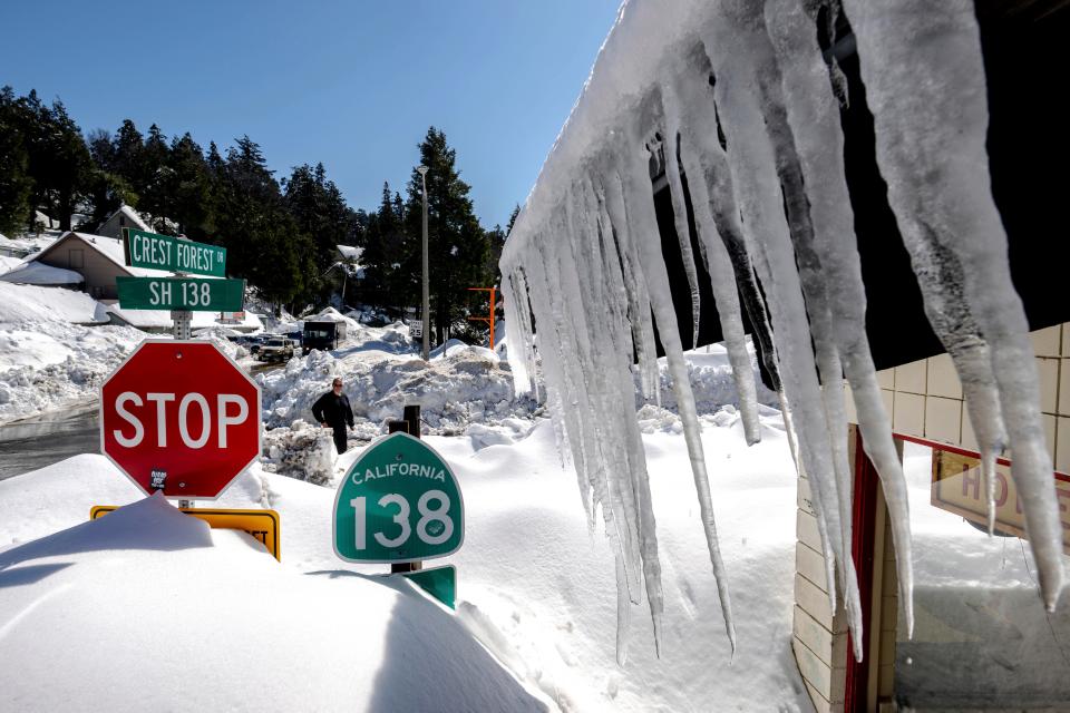 Snowfall surrounds businesses in Crestline, Calif., Friday, March 3, 2023, following a huge snowfall that buried homes and businesses.