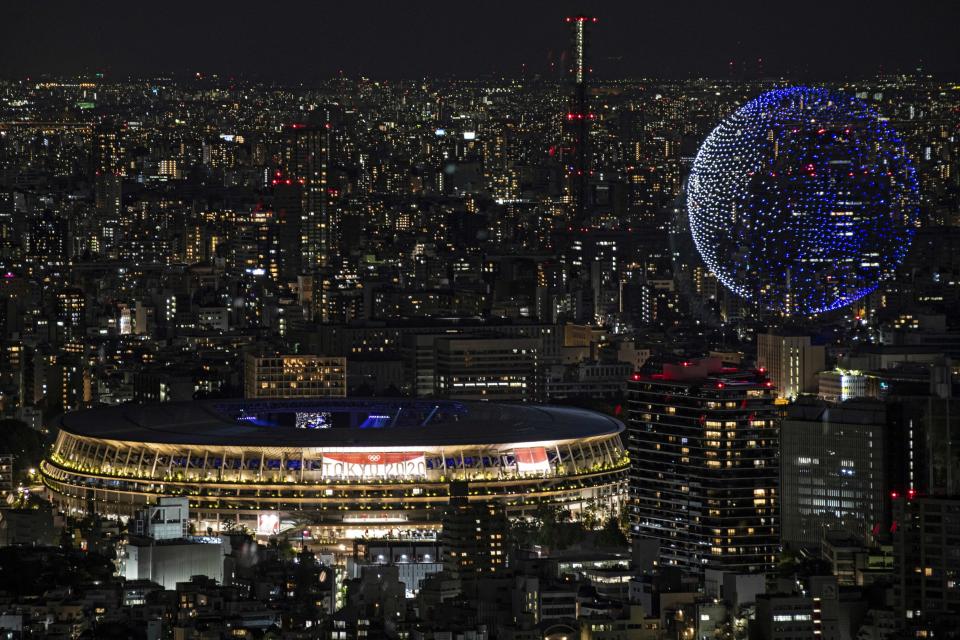 TOPSHOT - Drones fly to form an image of the Earth in the sky over the Olympic Stadium during the opening ceremony of the Tokyo 2020 Olympic Games, in Tokyo, on July 23, 2021. (Photo by Charly TRIBALLEAU / AFP) (Photo by CHARLY TRIBALLEAU/AFP via Getty Images)