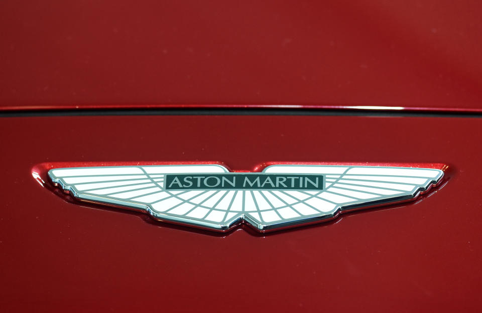 The Prince of Wales places a logo on the new Aston Martin DBX at the new Aston Martin Lagonda factory in Barry, Wales.