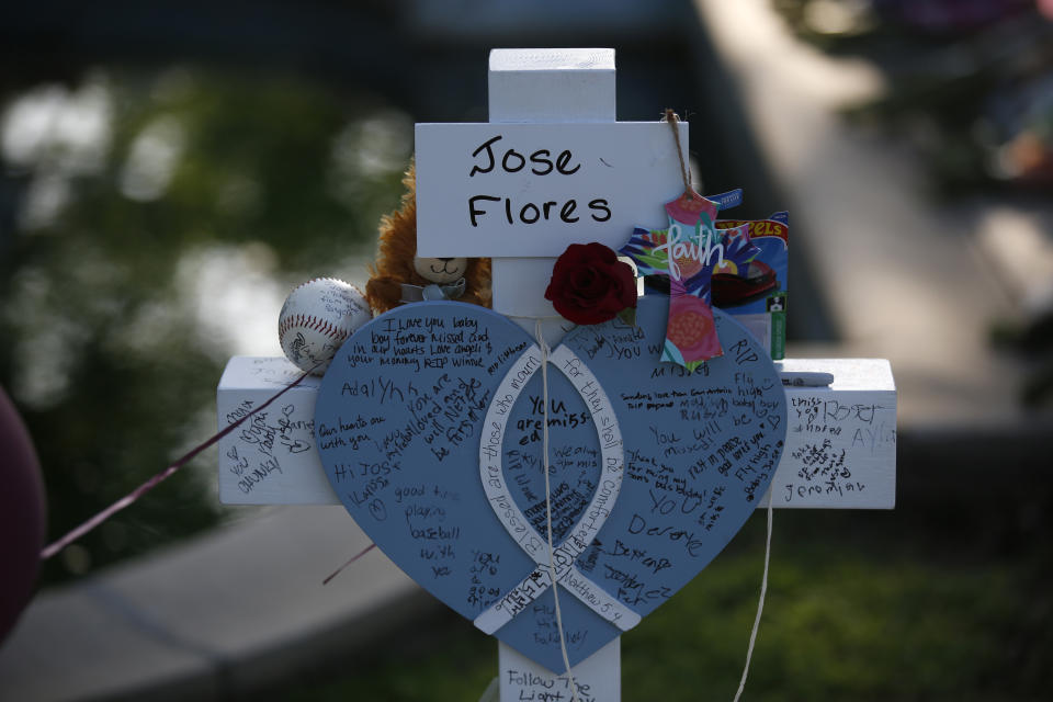 Jose Flores' cross stands at a memorial site for the victims killed in this week's shooting at Robb Elementary School in Uvalde, Texas, Friday, May 27, 2022. (AP Photo/Dario Lopez-Mills)