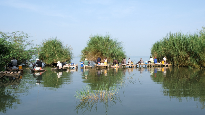 Men sit on self-made platforms to fish on Lake Tanganyika in Bujumbura, Burundi - Wednesday 16 March 2022