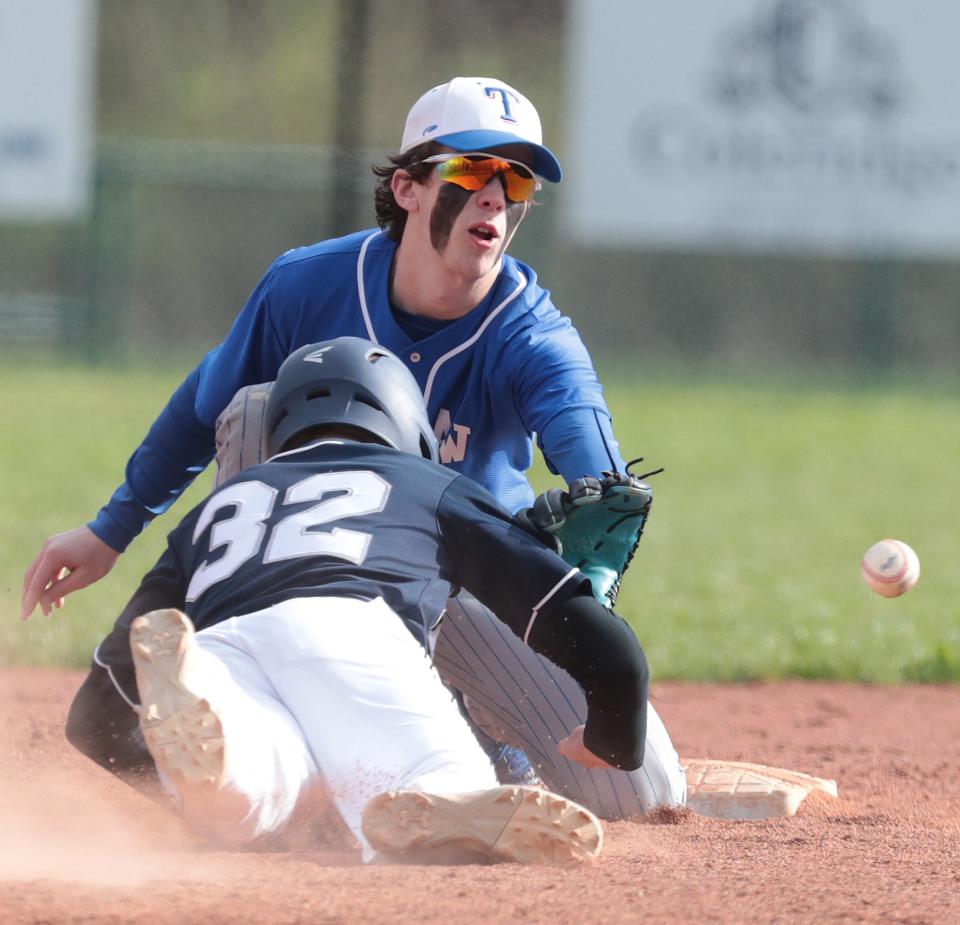 Fairless' Tyler Gaal (32) dives safely back to second base as Tuslaw's Caden Gardner awaits the throw during Wednesday's game.