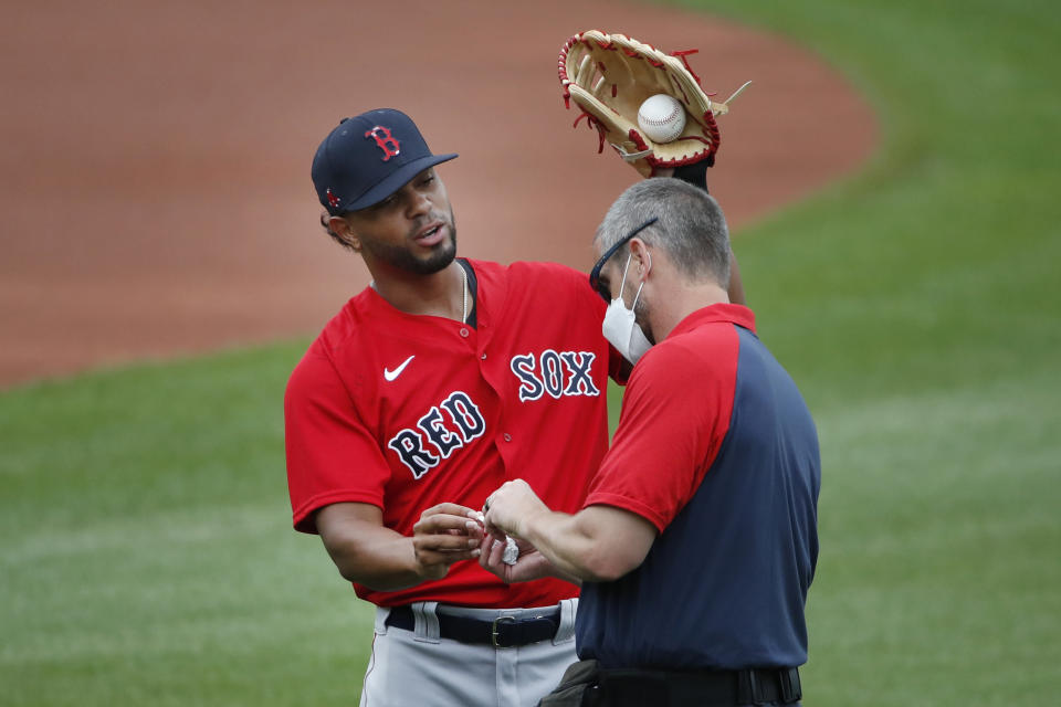 Boston Red Sox's Xander Bogaerts receives treatment on his hand during baseball training camp at Fenway Park, Monday, July 6, 2020, in Boston. (AP Photo/Elise Amendola)