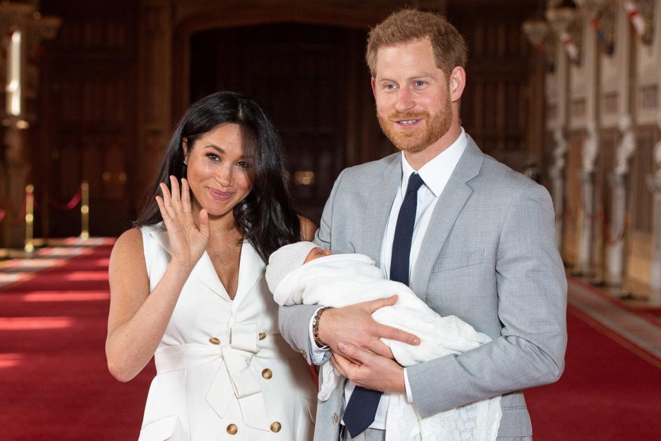 Britain's Prince Harry, Duke of Sussex (R), and his wife Meghan, Duchess of Sussex, pose for a photo with their newborn baby son, Archie Harrison Mountbatten-Windsor, in St George's Hall at Windsor Castle in Windsor, west of London on May 8, 2019. (Photo by Dominic Lipinski / POOL / AFP)        (Photo credit should read DOMINIC LIPINSKI/AFP/Getty Images)