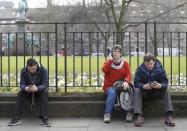 People listen and watch on their mobile devices as Scotland's First Minister Nicola Sturgeon demands a new independence referendum to be held in late 2018 or early 2019, once the terms of Britain's exit from the European Union have become clearer, outside Bute House, in Edinburgh, Scotland, Britain March 13, 2017. REUTERS/Russell Cheyne