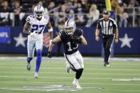 Las Vegas Raiders wide receiver Hunter Renfrow (13) catches a pass for a first down as Dallas Cowboys safety Jayron Kearse (27) gives chase in the second half of an NFL football game in Arlington, Texas, Thursday, Nov. 25, 2021. (AP Photo/Michael Ainsworth)