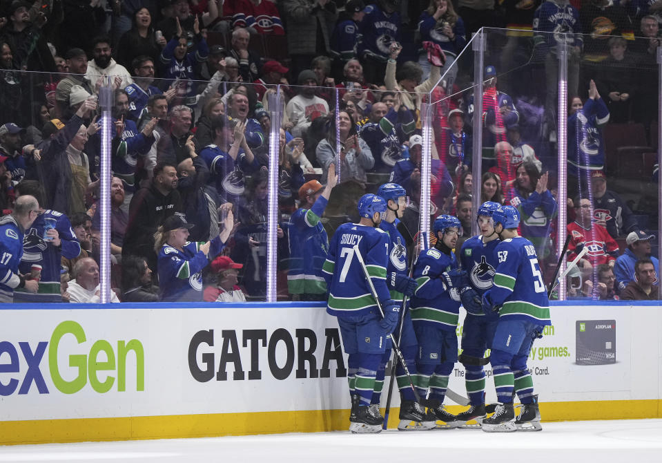 Vancouver Canucks' Carson Soucy, Tyler Myers, Conor Garland, Vasily Podkolzin and Teddy Blueger, from left, celebrate Garland's goal against the Montreal Canadiens during the second period of an NHL hockey game Thursday, March 21, 2024, in Vancouver, British Columbia. (Darryl Dyck/The Canadian Press via AP)