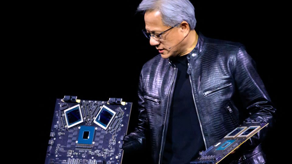 NVIDIA's CEO Jensen Huang displays products on stage at the SAP Center in San Jose, California, on March 18. - Josh Eledson/AFP/Getty Images