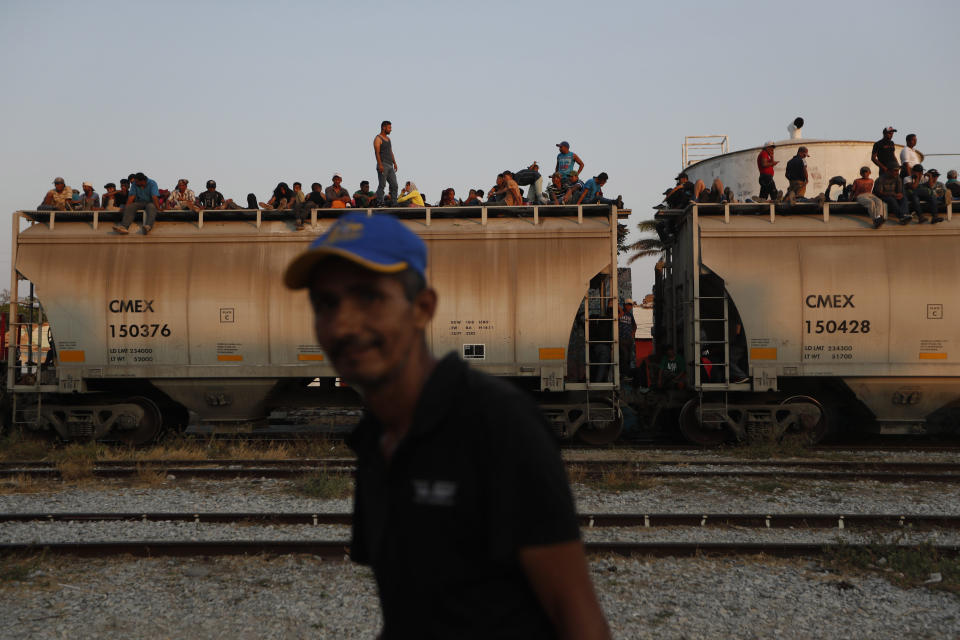 FILE - In this April 23, 2019 file photo, Central American migrants ride a freight train on their way to the U.S.-Mexico border, in Ixtepec, Oaxaca state, Mexico. Mexico President Andrés Manuel López Obrador said on Monday, May 20,2019 that U.S. support for economic development in Mexico and Central America is the best option for stemming the flow of immigrants, meanwhile the U.S. and Mexico are discussing an arrangement under which the U.S. government would guarantee some $10 billion in development investments for Mexico and Central America. (AP Photo/Moises Castillo, File)