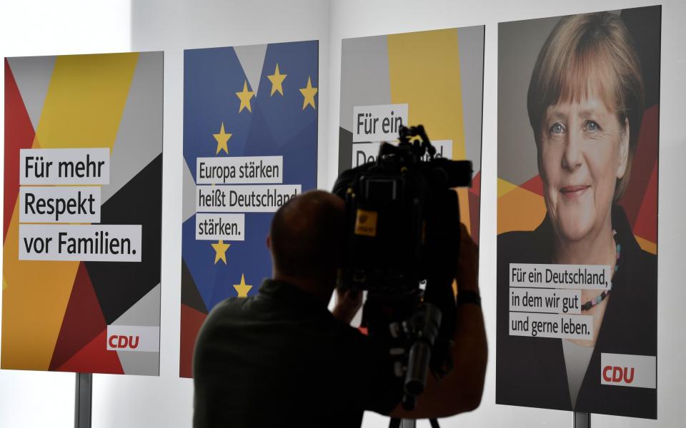 A cameraman films election posters of Germany's conservative Christian Democratic Union (CDU) party, - AFP or licensors