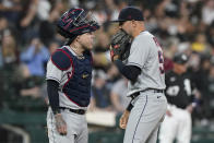 Cleveland Indians relief pitcher Blake Parker, right, talks with catcher Roberto Perez during the fifth inning of a baseball game against the Chicago White Sox in Chicago, Friday, July 30, 2021. (AP Photo/Nam Y. Huh)