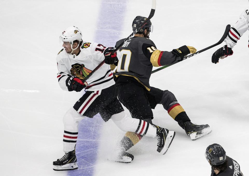 Vegas Golden Knights' Nicolas Roy (10) and Chicago Blackhawks' Dylan Strome (17) collide during the third period of an NHL hockey Stanley Cup first-round playoff series, Thursday, Aug. 13, 2020, in Edmonton, Alberta. (Jason Franson/The Canadian Press via AP)