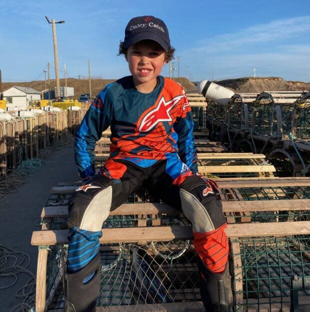 A Grade 2 student at Janeville Elementary School in Bathurst, Trent Collins skipped classes on Tuesday to work alongside his grandfather on opening day of lobster season. (Submitted by Alysa Collins - image credit)