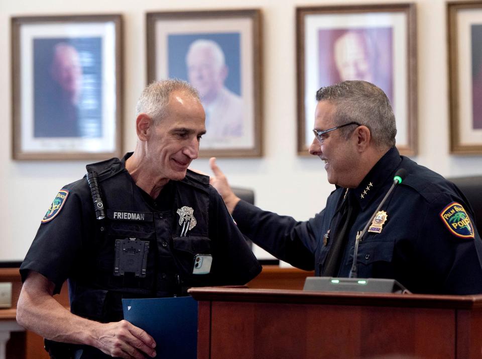 Palm Beach Police Officer Richard Friedman smiles as Police Chief Nicholas Caristo awards him Officer of the Month for July 2023.