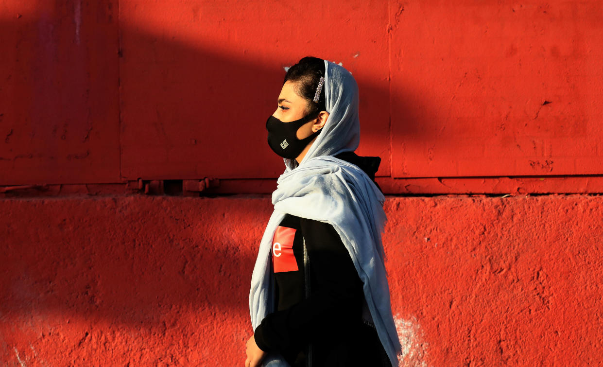 An Iranian woman wears a face mask as a Covid-19 coronavirus pandemic precaution, in Iran's capital Tehran on October 19, 2020. - Iran today announced 337 deaths from the novel coronavirus, a record high for a single day in the Middle East country hardest hit by the Covid-19 pandemic. The latest deaths brought to 30,712 the total number of fatalities since Iran reported its first coronavirus cases in February, health ministry spokeswoman Sima Sadat Lari said in televised remarks. (Photo by ATTA KENARE / AFP) (Photo by ATTA KENARE/AFP via Getty Images)