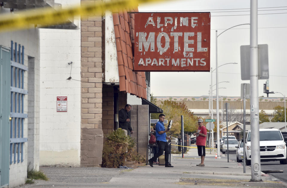 Investigators work at the scene of a fire at a three-story apartment complex early Saturday, Dec. 21, 2019 in Las Vegas. The fire was in first-floor unit of the Alpine Motel Apartments and its cause was under investigation, the department said. Authorities say multiple fatalities were reported and many more were injured. (AP Photo/David Becker)