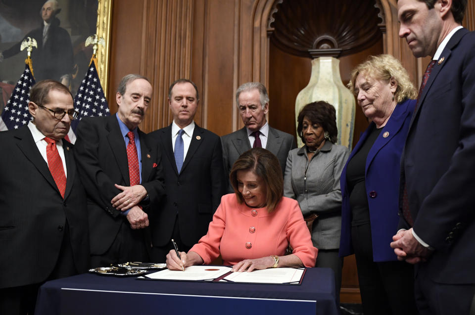 House Speaker Nancy Pelosi of Calif., signs the resolution to transmit the two articles of impeachment against President Donald Trump to the Senate for trial on Capitol Hill in Washington, Wednesday, Jan. 15, 2020. The two articles of impeachment against Trump are for abuse of power and obstruction of Congress. (AP Photo/Susan Walsh)