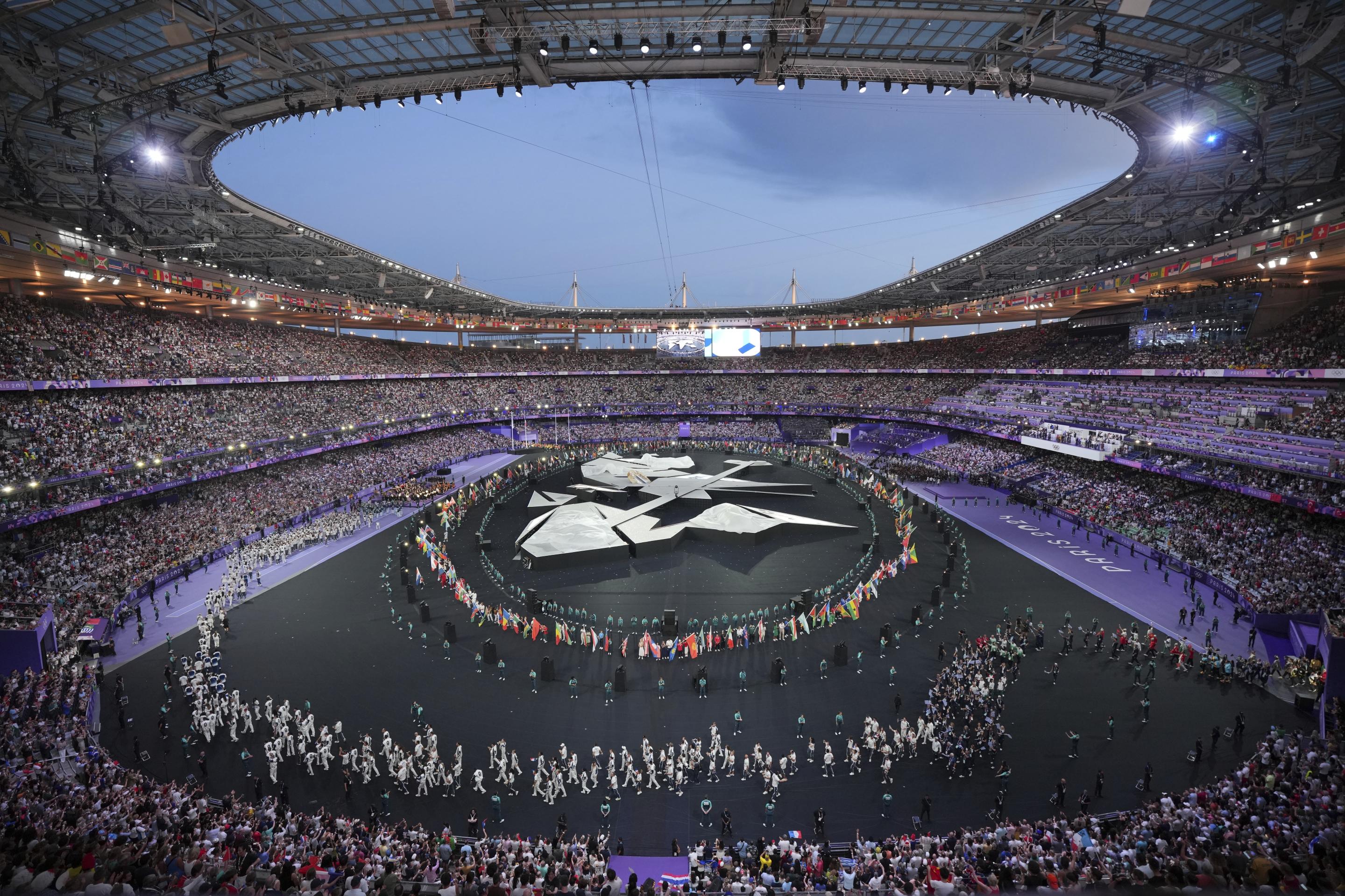 Flag bearers march during the 2024 Summer Olympics closing ceremony at the Stade de France on Sunday. 