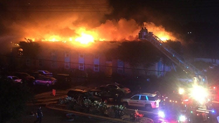 Firefighters battle a fire at the Iconic Village apartment complex on July 20, 2018. Five people died as a result of the blaze.