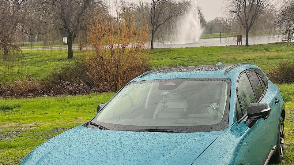 a blue car parked in a grassy area