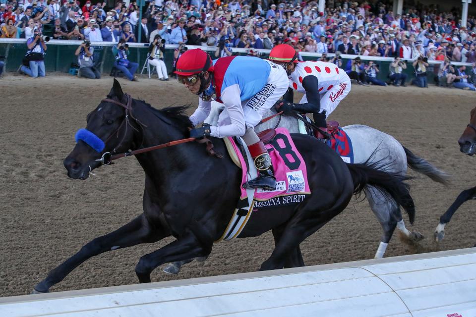 John Velazquez, aboard Medina Spirit, wins the Kentucky Derby. The horse was later disqualified, with the 2021 race awarded to Mandaloun.