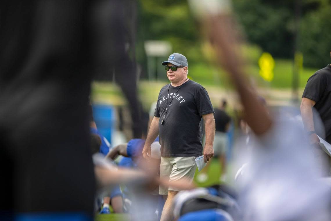UK head coach Mark Stoops watches his players warm up at the team’s fan day and open practice at the Joe Craft Football Training Center practice fields on Aug. 6.