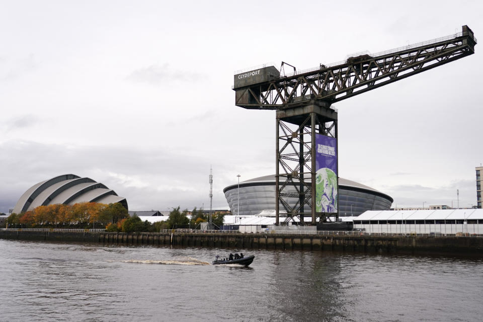 A police boat patrols the waters next to the Scottish Event Campus the venue for the COP26 U.N. Climate Summit in Glasgow, Scotland, Sunday, Oct. 31, 2021. The U.N. climate summit in Glasgow formally opens Sunday, a day before leaders from around the world gather in Scotland's biggest city to lay out their vision for addressing the common challenge of global warming. (AP Photo/Alberto Pezzali)