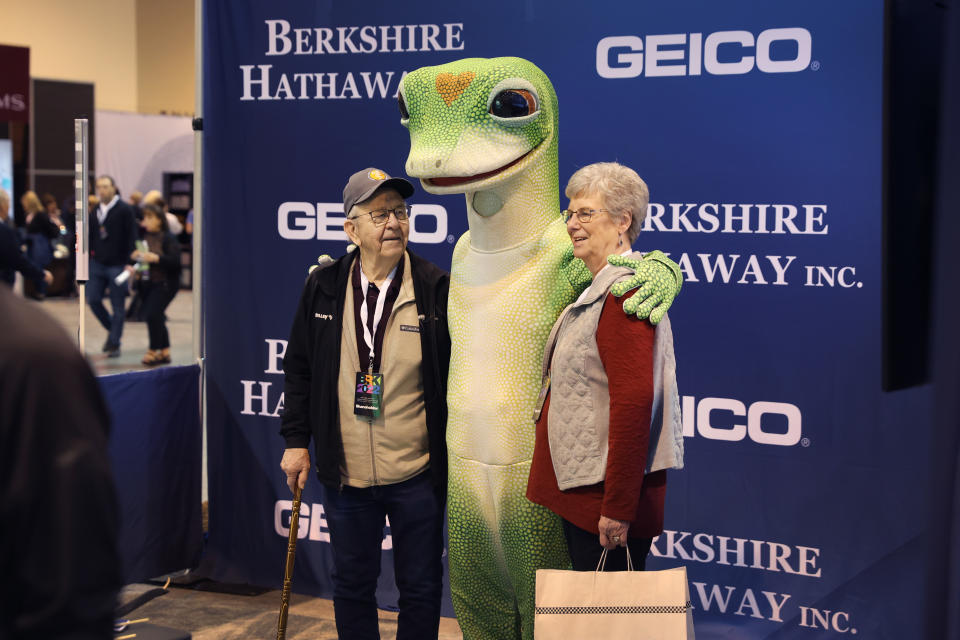 OMAHA, NE - APRIL 30: Stockholders pose for a photo with the Geico mascot during Berkshire Hathaway's annual shareholder meeting on April 30, 2022 in Omaha, Nebraska. This is the first time since 2019 that the annual shareholder event will be held due to the coronavirus pandemic.  (Photo by Scott Olson/Getty Images)