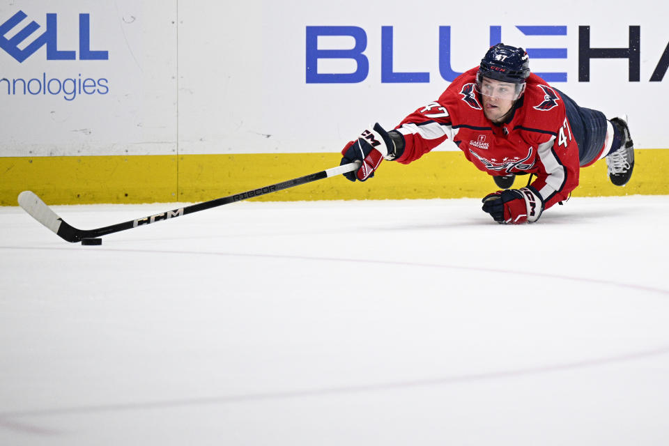 Washington Capitals left wing Beck Malenstyn reaches for the puck during the first period of an NHL hockey game against the Boston Bruins, Monday, April 15, 2024, in Washington. (AP Photo/Nick Wass)