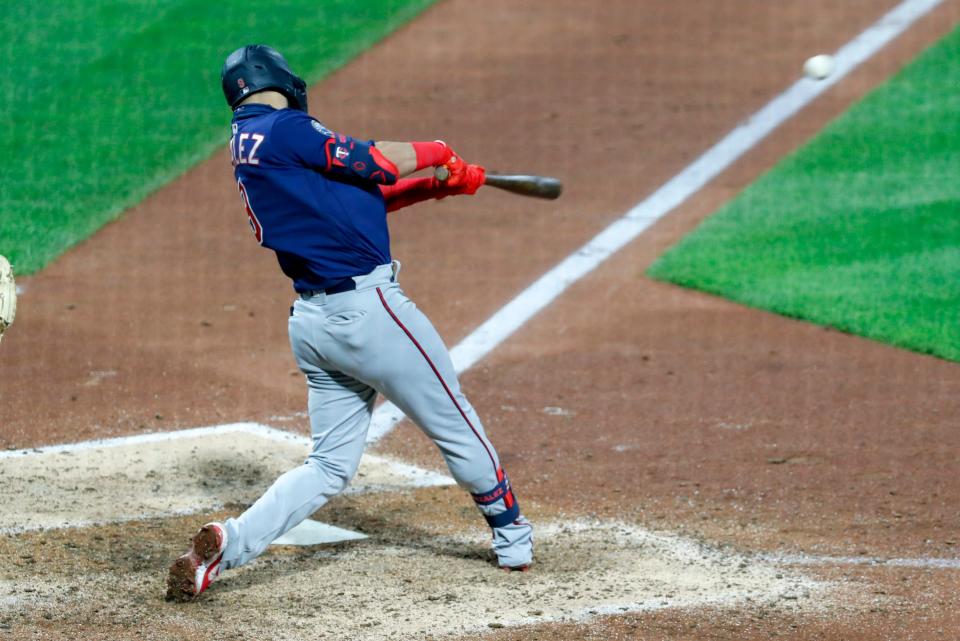 Minnesota Twins' Marwin Gonzalez drives in Byron Buxton with a hit in the ninth inning of a baseball game against the Pittsburgh Pirates, Wednesday, Aug. 5, 2020, in Pittsburgh. (AP Photo/Keith Srakocic)
