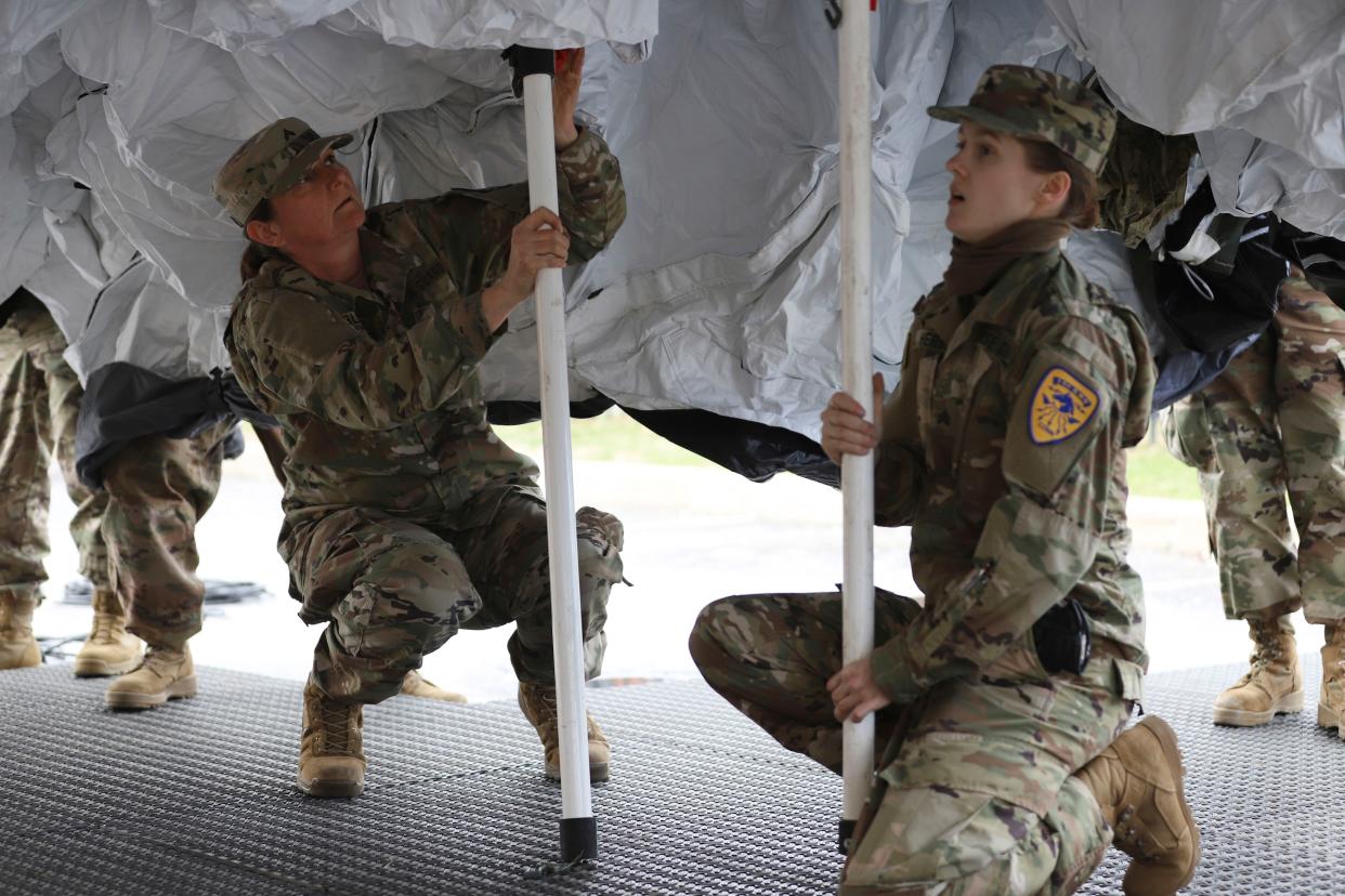 Members of the Governor's Food and Horse Guard set up a mobile tent outside Saint Francis Hospital on Tuesday, March 24, 2020 in Hartford, Conn.