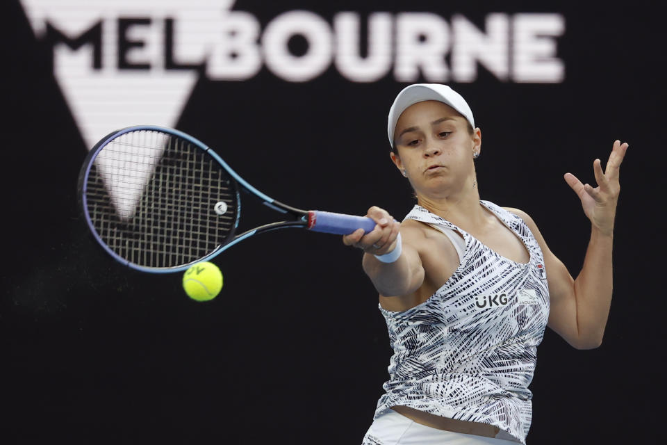 Ash Barty of Australia plays a forehand return to Lesia Tsurenko of Ukraine during their first round match at the Australian Open tennis championships in Melbourne, Australia, Monday, Jan. 17, 2022. (AP Photo/Hamish Blair)