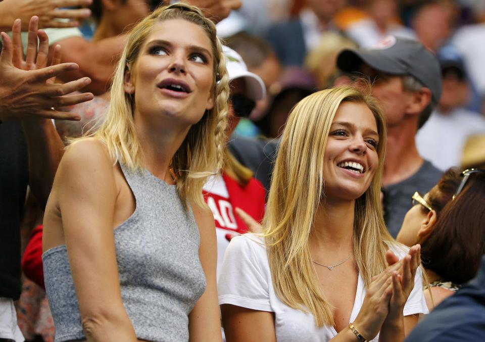 Danielle Knudson (R), girlfriend of Canada's Milos Raonic, reacts after he won his fourth round match against Switzerland's Stan Wawrinka at the Australian Open tennis tournament at Melbourne Park, Australia, January 25, 2016. REUTERS/Thomas Peter