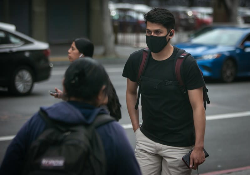 A A person walks in Downtown LA near the corner of 7th and Figueroa wearing a protective mask on Thursday, February 27, 2020 in Los Angeles, California. (Jason Armond / Los Angeles Times)