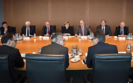 German Chancellor Angela Merkel chairs a meeting with ministers and security staff at the chancellery in Berlin, Germany, December 20, 2016, one day after a truck ploughed into a crowded Christmas market in the German capital. Back row from left are Klaus-Dieter Fritsche, Helge Braun, Chancellory Minister Peter Altmaier, Chancellor Angela Merkel, Matthias Machnig, Foreign Minister Frank-Walter Steinmeier and government spokesman Steffen Seibert. Front row from left are Holger Muench, Chief Commissioner of Germany's Bundeskriminalamt (BKA) Federal Crime Office, Interior Minister Thomas de Maiziere and Justice Minister Heilo Maas. REUTERS/Bundesregierung/Steffen Kugler/Handout via Reuters