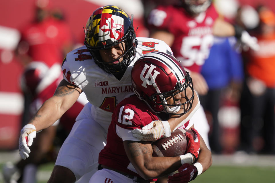 Indiana running back Jaylin Lucas (12) is tackled by Maryland's Caleb Wheatland (44) during the first half of an NCAA college football game, Saturday, Oct. 15, 2022, in Bloomington, Ind. (AP Photo/Darron Cummings)