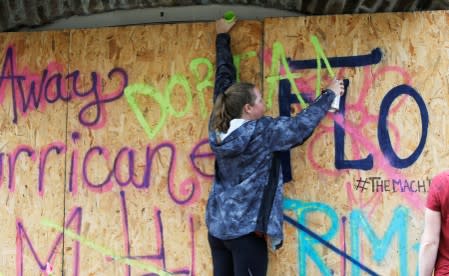 FILE PHOTO: Coreyanna Moore of Charleston adds the latest named storm to hurricane boards ahead of the arrival of Hurricane Dorian in Charleston