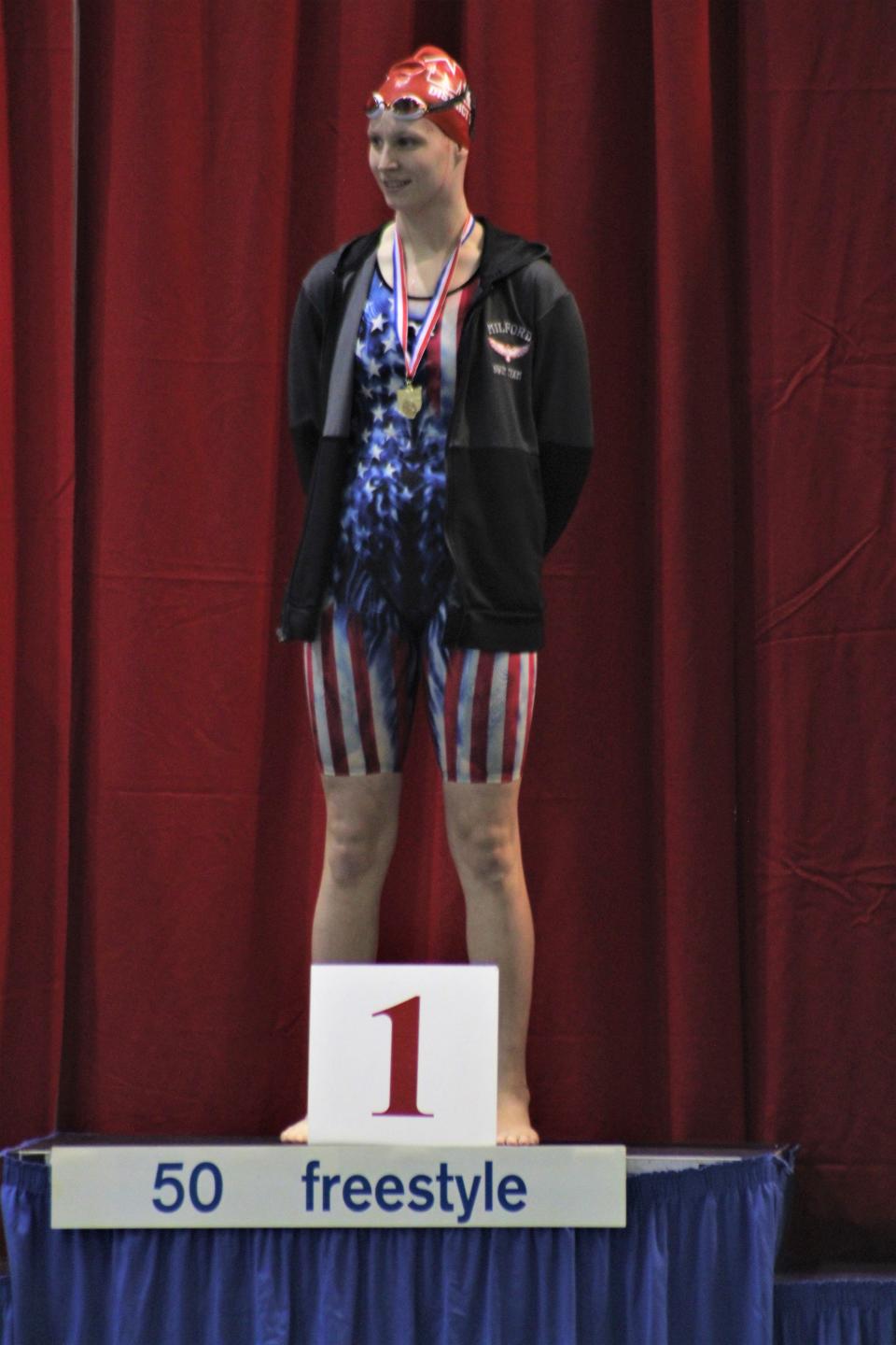 Milford senior Erin Fentress with her medal for winning a district title in the 50 freestyle during the OHSAA Southwest District Division I girls swimming championships Feb. 18, 2023 at Miami University