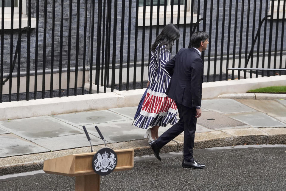 Britain's outgoing Conservative Party Prime Minister Rishi Sunak and his wife Akshata Murty walk from 10 Downing Street to a waiting car before going to see King Charles III to tender his resignation in London, Friday, July 5, 2024. Sunak and his Conservative Party lost the general election held July 4, to the Labour Party, whose leader Keir Starmer is set become Prime Minister later Friday. (Gareth Fuller/PA via AP)