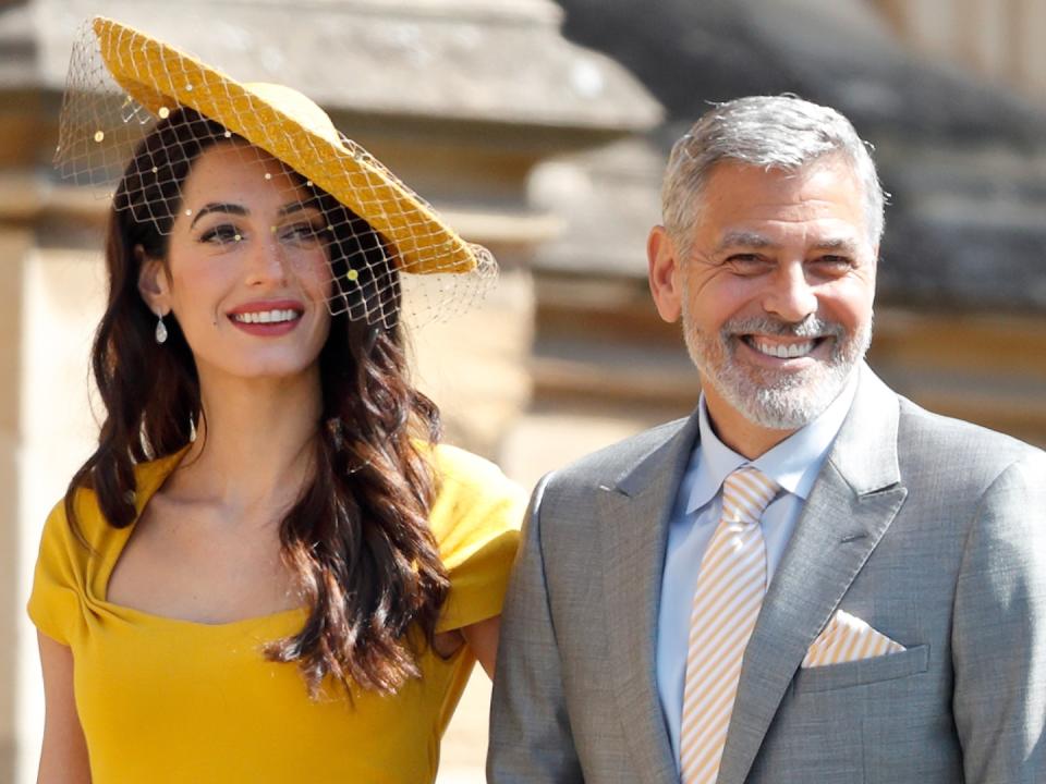 WINDSOR, UNITED KINGDOM - MAY 19: (EMBARGOED FOR PUBLICATION IN UK NEWSPAPERS UNTIL 24 HOURS AFTER CREATE DATE AND TIME) Amal Clooney and George Clooney attend the wedding of Prince Harry to Ms Meghan Markle at St George's Chapel, Windsor Castle on May 19, 2018 in Windsor, England. Prince Henry Charles Albert David of Wales marries Ms. Meghan Markle in a service at St George's Chapel inside the grounds of Windsor Castle. Among the guests were 2200 members of the public, the royal family and Ms. Markle's Mother Doria Ragland. 